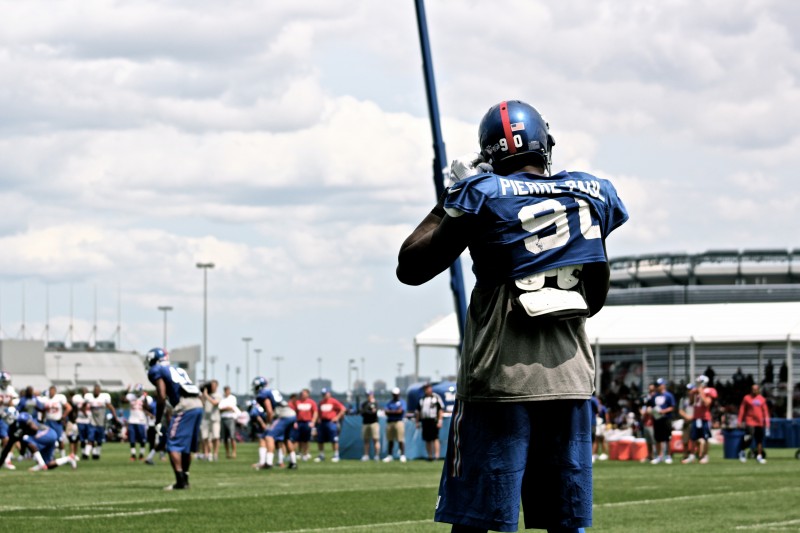 Jason Pierre-Paul straps on the helmet during training camp. Credit: BOBBY O'HARA/PureSportsNY