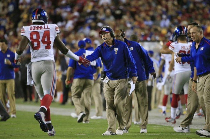ROB CARR/GETTY IMAGES Tight end Larry Donnell gets a high-five from Tom Coughlin during his three-touchdown night.