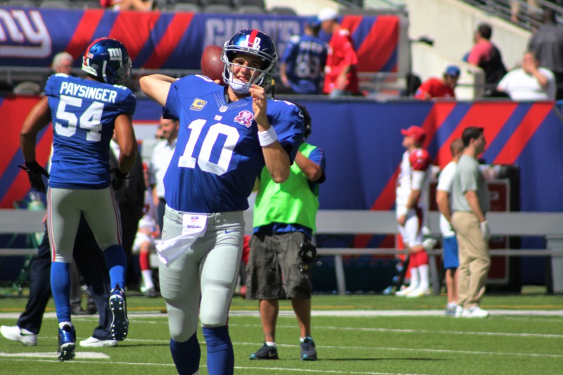 Eli Manning threw for 277 yards on Sunday vs Arizona including 2 touchdowns and 2 interceptions, nut showed signs of improvement. Credit: BOBBY O'HARA/PureSportsNY
