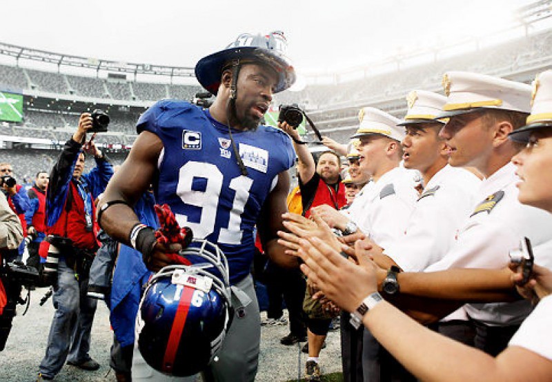 Former Giants Justin Tuck wears a NYC fireman's hat in remembrance of the 9/11 attacks. JOHN MUNSON/THE STAR-LEDGER