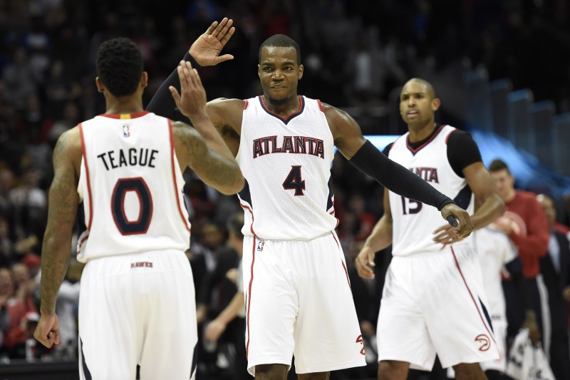 Jan 23, 2015; Atlanta, GA, USA; Atlanta Hawks guard Jeff Teague (0) and forward Paul Millsap (4) react late in the game as the Hawks win their team record 15th consecutive game against the Oklahoma City Thunder at Philips Arena. The Hawks defeated the Thunder 103-93. Mandatory Credit: Dale Zanine-USA TODAY Sports