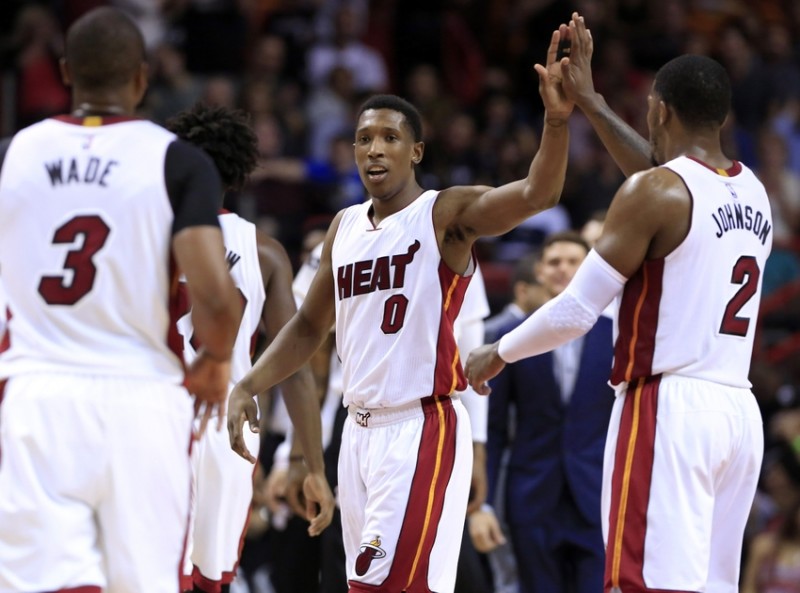 Mar 25, 2016; Miami, FL, USA; Miami Heat guard Josh Richardson (0) celebrates with forward Joe Johnson (2) and guard Dwyane Wade (3) in the second half of a game against the Orlando Magic at American Airlines Arena. The Heat won 108-97. Mandatory Credit: Robert Mayer-USA TODAY Sports