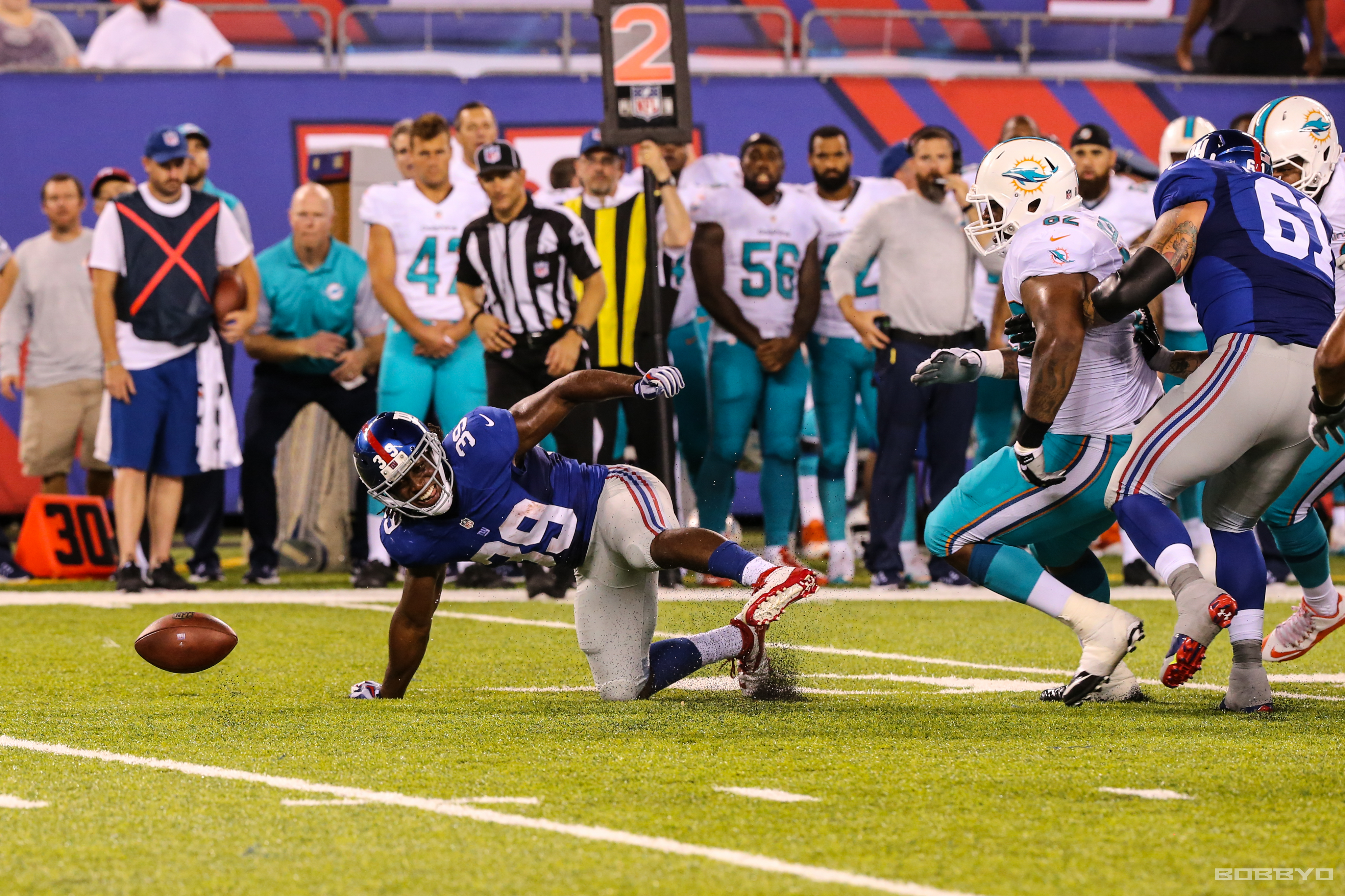 Paul Perkins Fumbles the handoff that would lead to a Miami touchdown drive (photo: Bobby O'Hara)